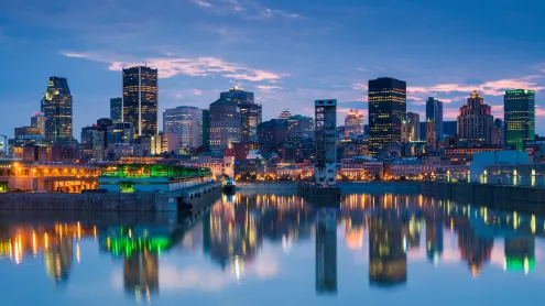 Montreal skyline reflecting in St. Lawrence River, Quebec (© Walter Bibikow/Stone/Getty Images)