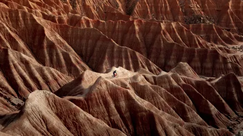 Cyclist in Bardenas Reales Natural Park and Biosphere Reserve, Navarra, Spain (© Artur Debat/Getty Images)